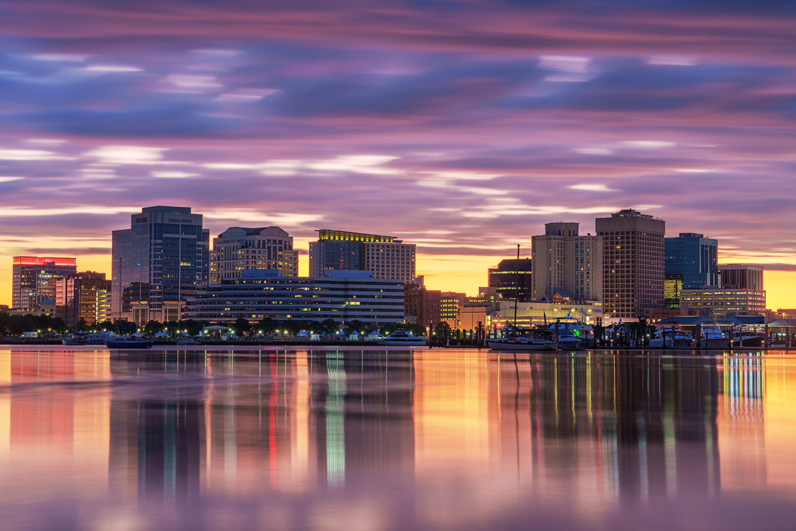 Norfolk, Virginia, USA downtown city skyline with dramatic morning clouds on the Elizabeth River.